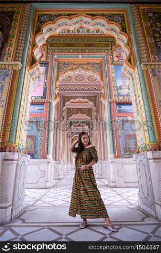 Young asian woman posing at Patrika gate. The ninth gate of Jaipur, Jaipur, Rajasthan, India