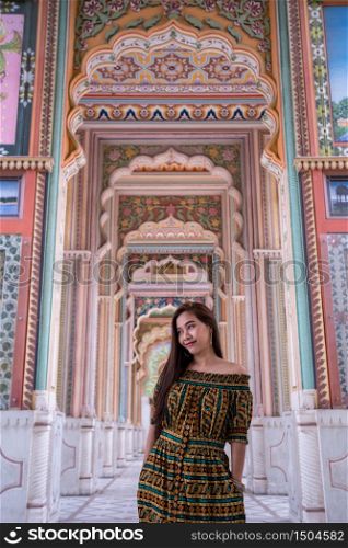 Young asian woman posing at Patrika gate. The ninth gate of Jaipur, Jaipur, Rajasthan, India