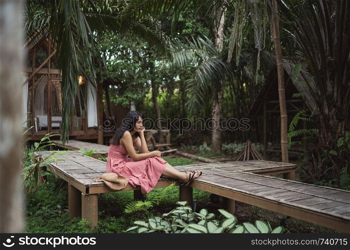 Young Asian woman relax in forest, Beautiful female happy using relax time in nature. Lifestyle women travel in forest concept.