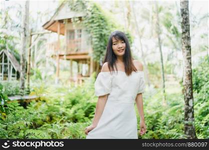 Young Asian woman relax in forest, Beautiful female happy using relax time in nature. Lifestyle women travel in forest concept.