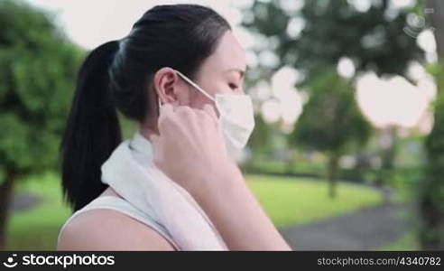 Young asian woman remove face mask before exercise, infectious diseases protection awareness, risk management, stay healthy during pandemic covid19 corona virus distancing. carefree risk in public