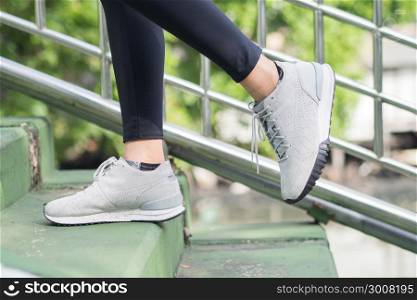 Young asian woman running on sidewalk in morning. Health conscious concept with copy space. Young sport asian woman running upstairs on city stairs. Fitness sport people and healthy lifestyle concept.
