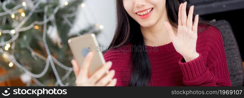 Young asian woman selfie video call online with friends in Christmas day on phone at home with social distancing, new normal, female video conference on smartphone, communication and holiday concept.