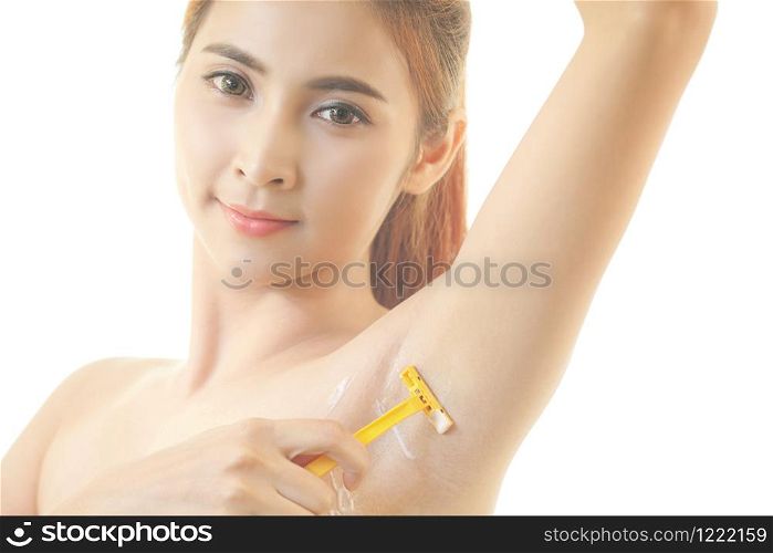 Young asian woman shaving armpit with razor isolated on white background