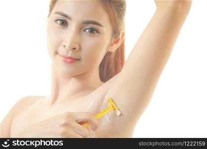 Young asian woman shaving armpit with razor isolated on white background