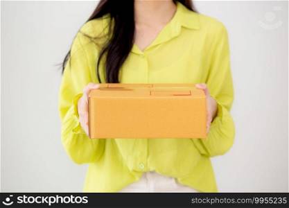 Young asian woman smiling and holding cardboard box at home, happy female carrying parcel box giving, present and gift, packaging for deliver, online shopping store and service concept.