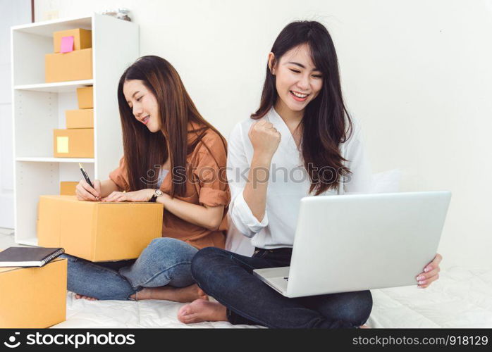 Young Asian woman startup small business entrepreneur SME distribution warehouse with parcel mail box. Owner home office concept. Online marketing and product packaging and delivery service.