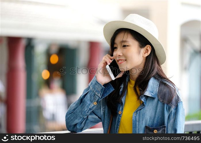 Young asian woman taking phone in city outdoors background, people on phone in urban lifestyles