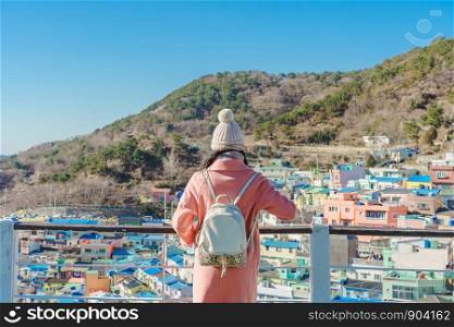 Young asian woman traveler with backpack traveling into the gamcheon Culture Village located at Busan, South Korea