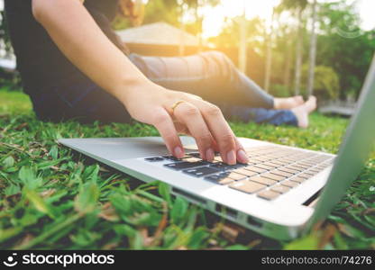 young asian woman using laptop at a outdoors