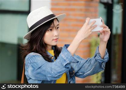 Young asian woman using smart phone in city outdoors background, people outdoor with technology, people on phone, lifestyle