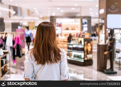 Young asian woman walking in clothes store at the mall, Woman lifestyle concept
