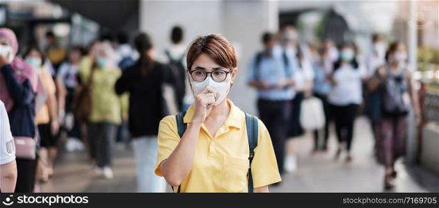 young Asian woman wearing protection mask against Novel coronavirus (2019-nCoV) or Wuhan coronavirus at public train station,is a contagious virus that causes respiratory infection.Healthcare concept
