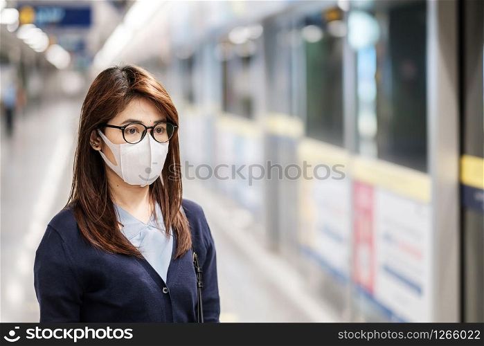 young Asian woman wearing protection mask against Novel coronavirus or Corona Virus Disease (Covid-19) at airport, is a contagious virus that causes respiratory infection.Healthcare concept