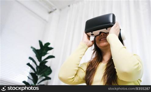 Young Asian woman wearing virtual reality touching air during the VR experience  Future technology concept