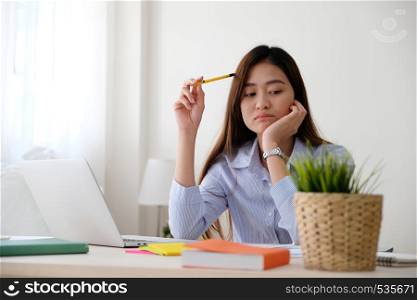 Young asian woman with frustrated expression while working with laptop computer, working from home, casual office lifestyle