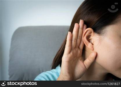 Young Asian woman with hearing problem.