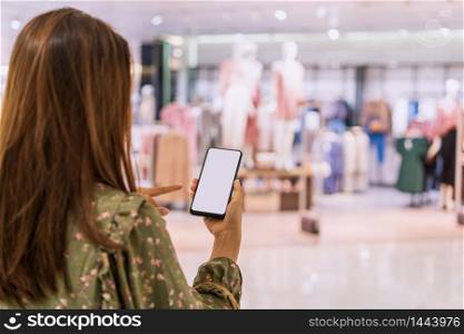 Young asian woman with shopping bags using smart phone and shopping at mall, Woman lifestyle concept