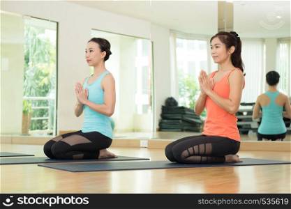 Young asian women practicing yoga, meditation in lotus pose, healthy lifestyle, wellness, well being