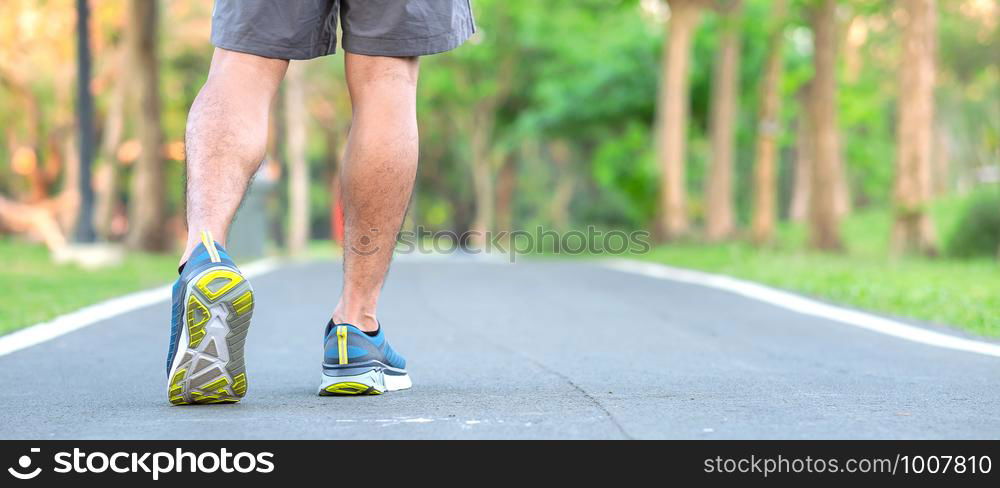 Young athlete man with running shoes in the park outdoor, male runner ready for jogging on the road outside, asian Fitness walking and exercise on footpath in morning. wellness and sport concepts