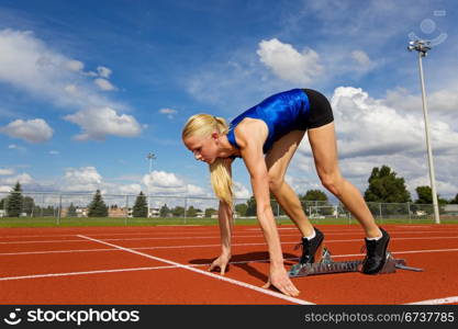 Young athlete on the starting blocks ready to race