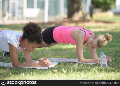 young athletes friends doing push ups outdoor