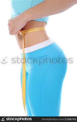 Young athletic women measuring waist. Isolated on white background