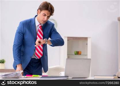 Young attractive businessman working in the office  
