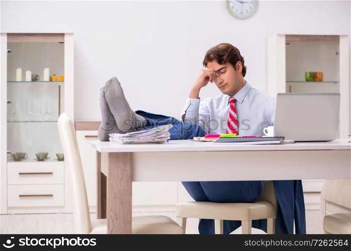 Young attractive businessman working in the office  . The young attractive businessman working in the office  