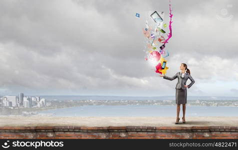 Young attractive businesswoman and color icon in her palm. More color and creativity