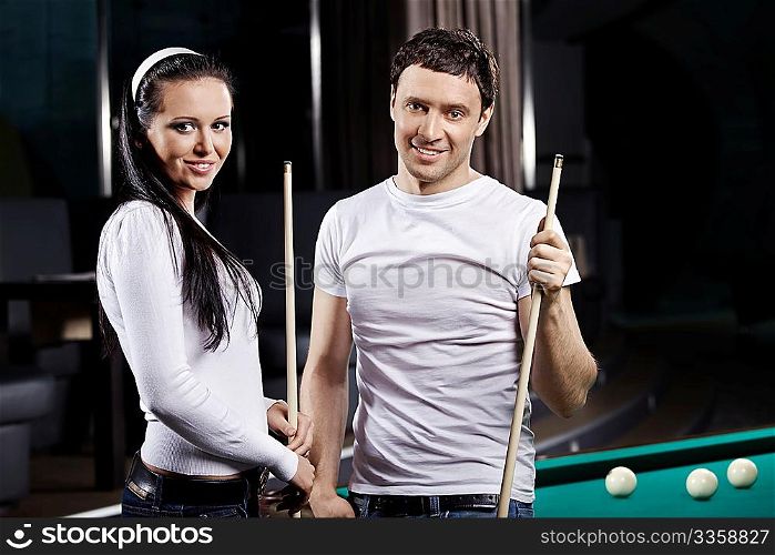 Young attractive couple at a billiard table