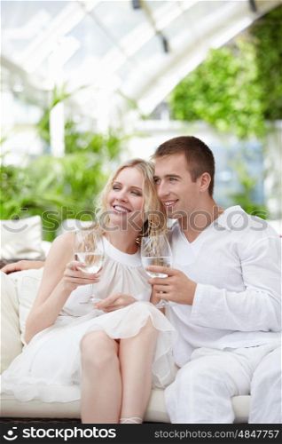 Young attractive couple in a white restaurant