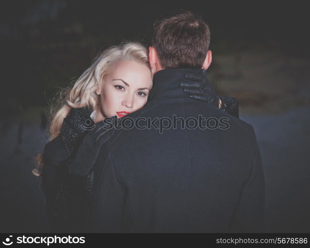 Young attractive couple in black autumn coat