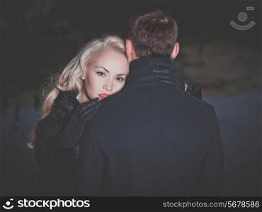 Young attractive couple in black autumn coat