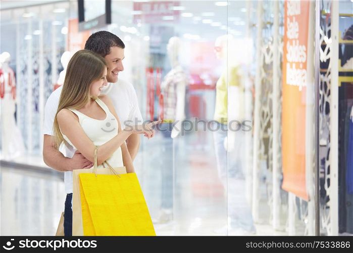 Young attractive couple in shop window