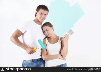 Young attractive couple on the background of painted wall