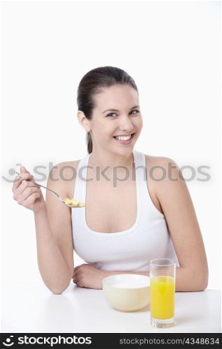 Young attractive girl breakfast corn flakes on a white background