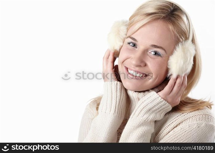 Young attractive girl in headphones on white background