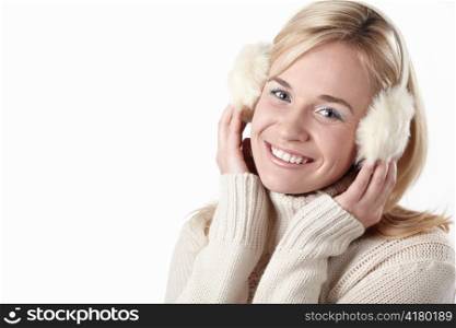 Young attractive girl in headphones on white background