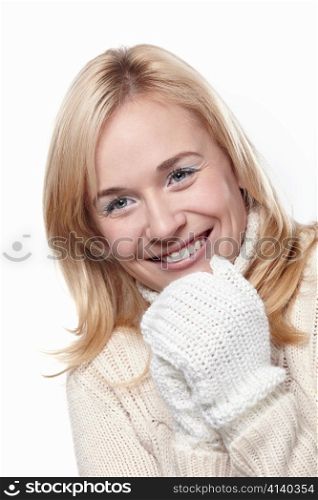 Young attractive girl in the mittens on a white background