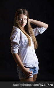 Young attractive girl in white shirt, studio isolated shot