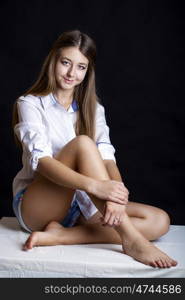 Young attractive girl in white shirt, studio isolated shot