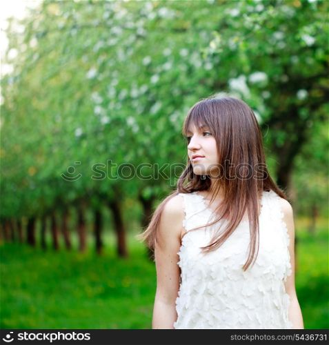 Young attractive girl is walking in the garden