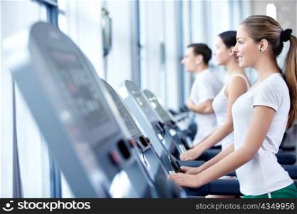 Young attractive girl on the treadmill