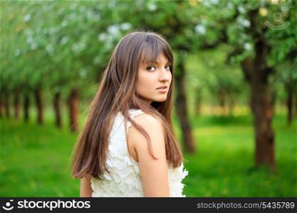 Young attractive girl running in the garden