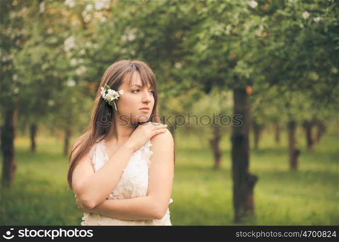 Young attractive girl running in the garden. Girl running in the garden