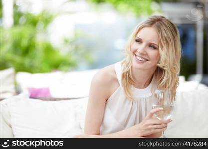 Young attractive girl with a glass at a restaurant