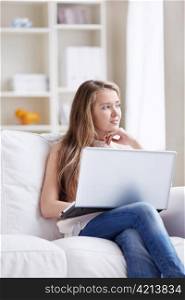 Young attractive girl with a laptop at home