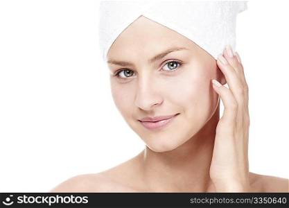 Young attractive girl with a towel on his head on a white background