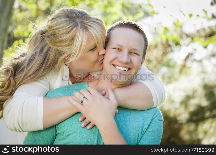 Young Attractive Loving Couple Hugging in the Park.